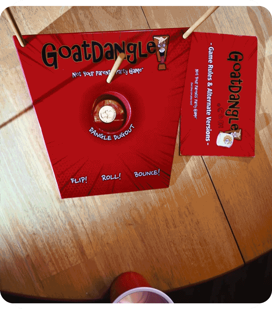 GoatDangle game components on wooden table.